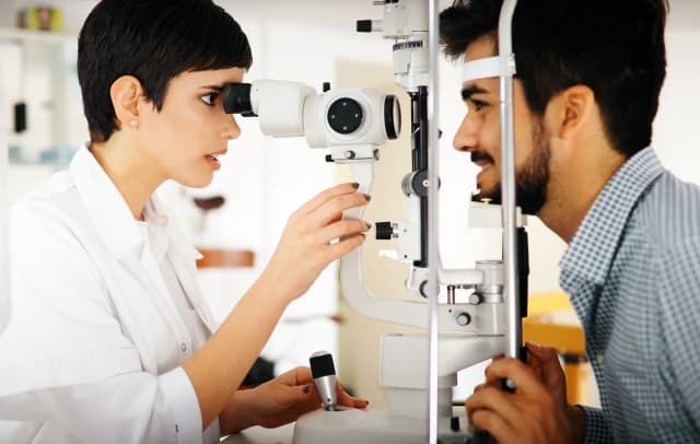 Healthcare student learning eye examination skills with professional equipment at Virohan.